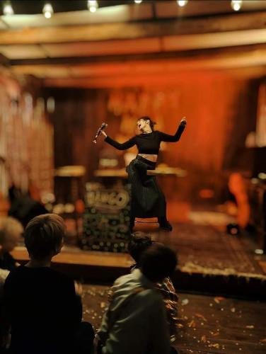 a woman standing on a stage in front of a group of people at Przystań Tło dla Mew in Rydzewo