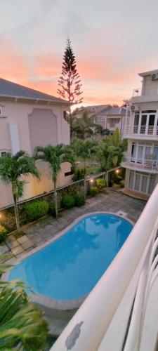 a view of a swimming pool from the balcony of a apartment at Coco Lux Studio Grand Baie in Grand Baie