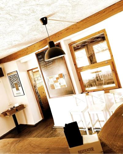 a dining room with white chairs and a table at Przystań Tło dla Mew in Rydzewo