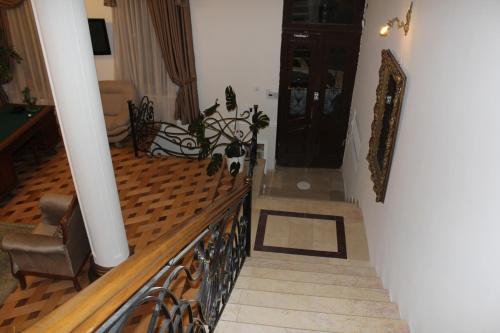 a living room with a staircase and aoyer with a stair at Luxor Garden in Batumi