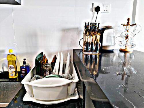 a kitchen counter with a sink on a counter top at Apartment in Georgetown 3BR-10pax in Jelutong