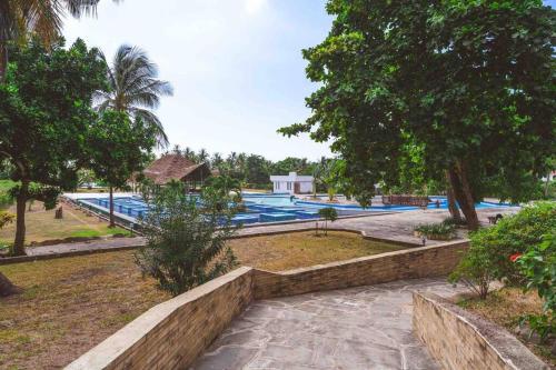 a view of a swimming pool in a resort at Golden Beachfront Apartment Diani in Ukunda