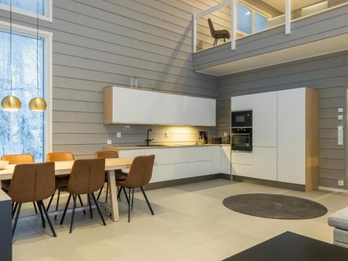 a kitchen and dining room with a table and chairs at Holiday Home Levin hiihtäjä by Interhome in Sirkka