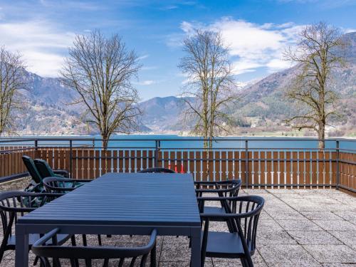 a table and chairs on a balcony with a view of the mountains at Apartment Superior-2 by Interhome in Molina di Ledro