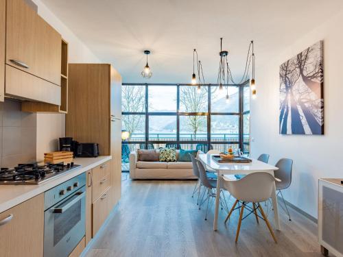 a kitchen and living room with a table and chairs at Apartment Superior-2 by Interhome in Molina di Ledro