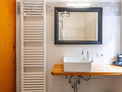 a bathroom with a sink and a mirror at Apartment Superior-2 by Interhome in Molina di Ledro