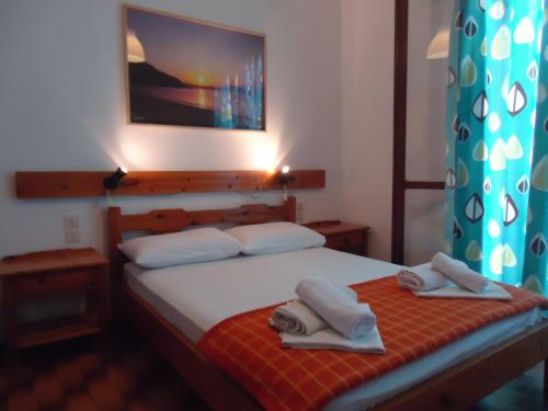 a bedroom with a bed with towels on it at PensionMargaritaKotroniSkiathos in Skiathos Town
