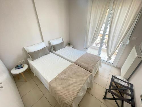 a small bedroom with a bed and a window at Elia Family Apartment in Neos Marmaras
