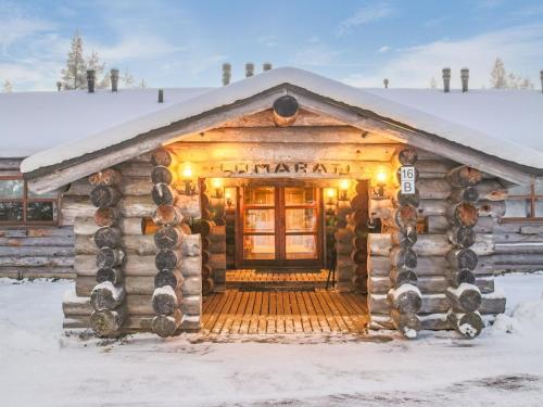 a log cabin in the snow with lights at Holiday Home Lomarati 3 by Interhome in Saariselka