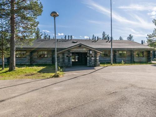 a log cabin with a street light in front of it at Holiday Home Lomarati 3 by Interhome in Saariselka