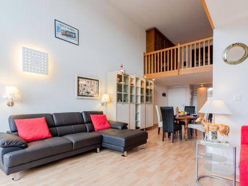 a living room with a couch and a table at Apartment Les Lofts-17 by Interhome in Dives-sur-Mer