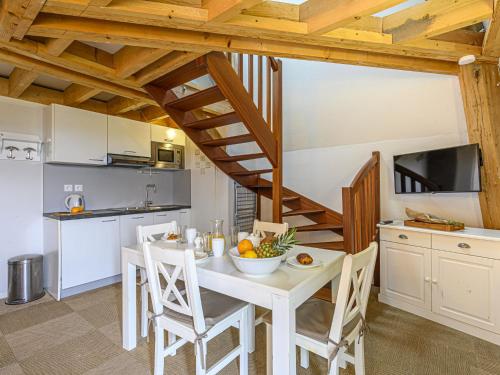 a kitchen and dining room with a white table and chairs at Apartment Le Château de Kergonano-20 by Interhome in Baden