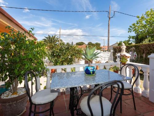 a blue table and chairs on a balcony at Holiday Home Villa Angeles by Interhome in L'Ametlla de Mar
