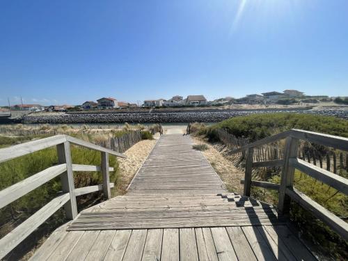 a wooden bridge over a body of water at Apartment L'Oustalet-6 by Interhome in Mimizan