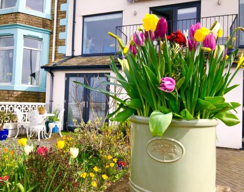 a large pot of flowers in front of a house at Sunsets, Sandylands Prom Morecambe in Morecambe
