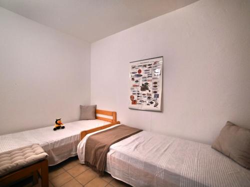 une chambre avec deux lits et un animal farci assis entre eux dans l'établissement Apartment l'Oasis by Interhome, à Dolus-d'Oléron