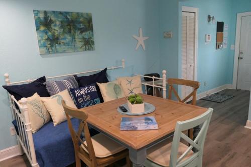 a living room with a table and a couch at Barra Villa Resort House II in Fort Myers