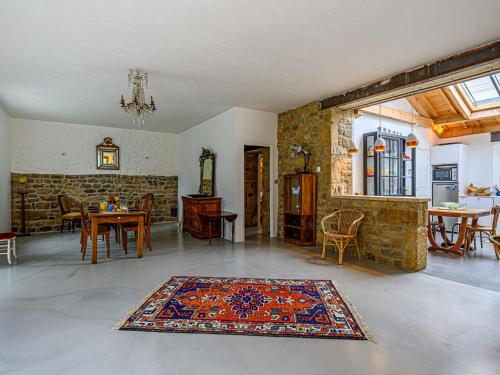 a living room with a table and a rug on the floor at Holiday Home Maison Ty Mad by Interhome in Belz