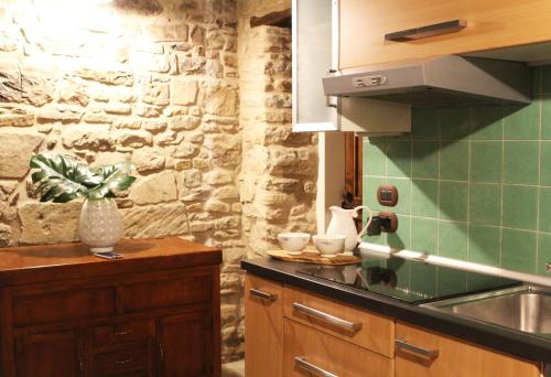 a kitchen with a sink and a stone wall at Ca' Nobili - Charming Country House 