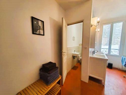 a bathroom with a sink and a toilet and a window at La Sigeannaise - Maison familiale près des commerces et des plages in Sigean