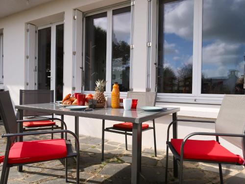 a table and chairs sitting on a patio at Holiday Home Ar Goualaniged by Interhome in Esquibien