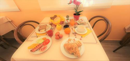 a white table with plates of food on it at Hotel Alessi** Rimini in Rimini