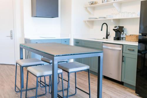 a kitchen with a blue table and stools at Sea Palms Resort St Simons Island in Saint Simons Island