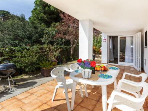 a patio with a table and chairs and a grill at Holiday Home Escorpio-1 by Interhome in Tossa de Mar