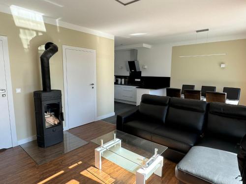 a living room with a couch and a fireplace at Luxuriöses Ferienhaus nähe Kattowitz in Bytom