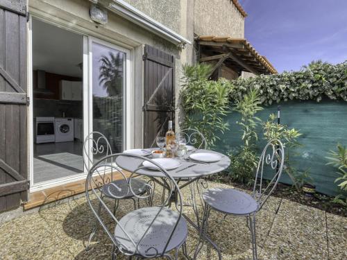 a patio with a table and chairs on a balcony at Holiday Home bonnegrace by Interhome in Six-Fours-les-Plages