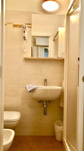 a bathroom with a sink and a toilet at Hotel Alessi** Rimini in Rimini