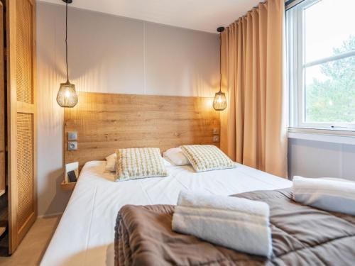 une chambre avec deux lits et une fenêtre dans l'établissement Holiday Home Mobilhome Luxe 4 personnes 2 chambres by Interhome, à Prunières