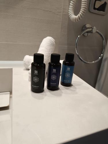 three bottles sitting on a counter in a bathroom at Bay Lodge Boutique Hotel in Jounieh