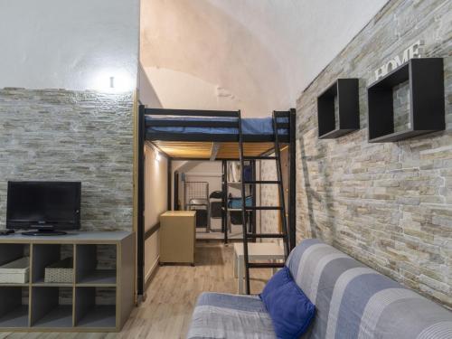 a bedroom with a bunk bed and a brick wall at Holiday Home Kicca by Interhome in Sanremo