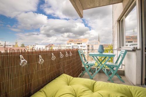 a patio with a table and chairs on a balcony at Special BLUE TIGER Apartment Basel, Messe Kleinbasel 10-STAR in Basel