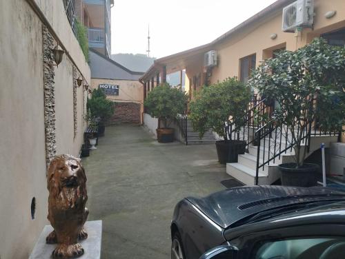 a statue of a dog sitting next to a building at Two Lions Hotel in Tbilisi City