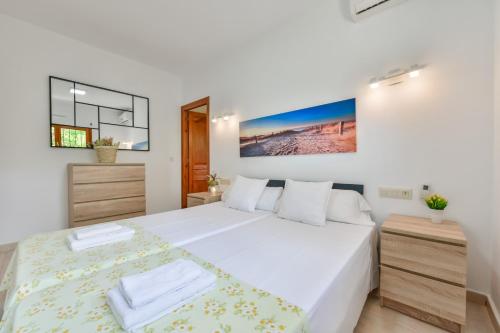 a white bedroom with a large bed and a window at Villas Guzman - Alex in Benissa