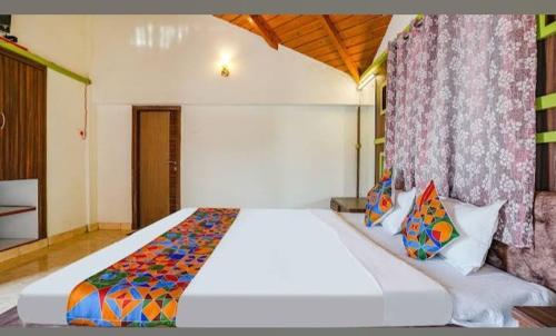 a bedroom with a large white bed in a room at Hotel Mint Resort in Jālna