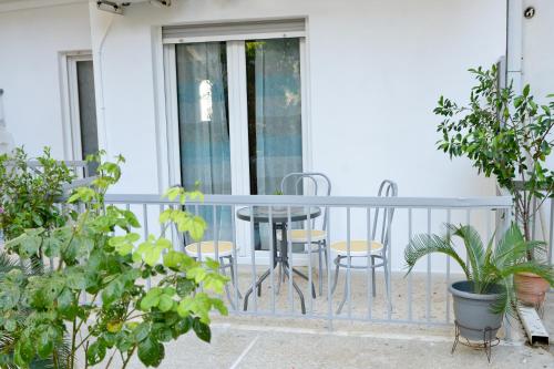 a balcony with a table and chairs and plants at Dream apartment in Kallithea in Athens