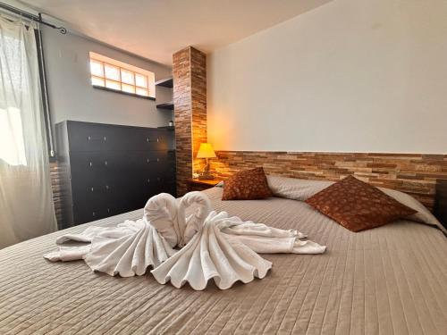 a large bed with two white dresses on it at Apartment Domu Franziska - Beach & City Holiday in Cagliari