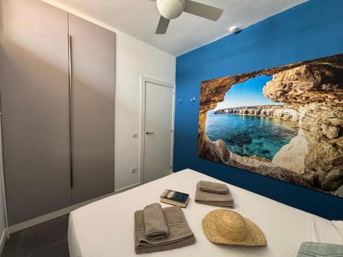 a room with a bed with a painting on the wall at Loris Home playa ingles 50mt from Yumbo by luca properties gran canaria in San Bartolomé de Tirajana