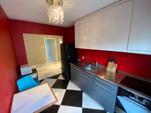 a kitchen with a black and white checkered floor at Fancy 1 bedroom flat in the city center (SF19) in Zurich