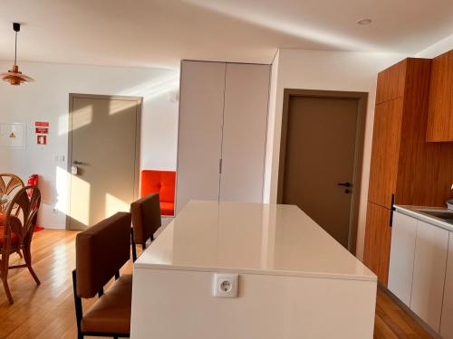 a kitchen and dining room with a white counter top at Casa Sao Bento in Arcos de Valdevez