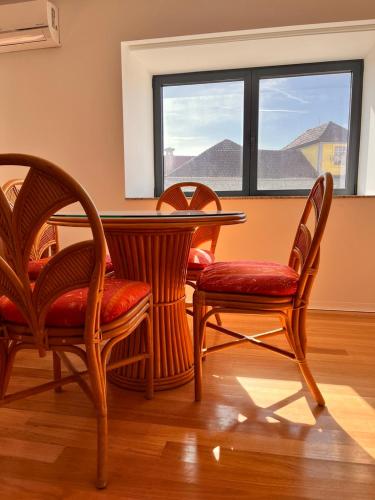 a dining room table and chairs with a window at Casa Sao Bento in Arcos de Valdevez