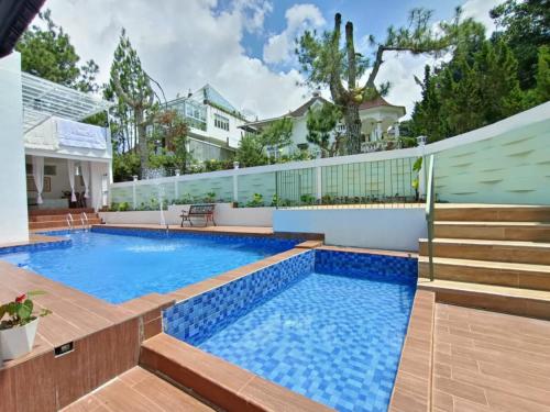a swimming pool with blue water in a house at Villa Puncak in Cikundul