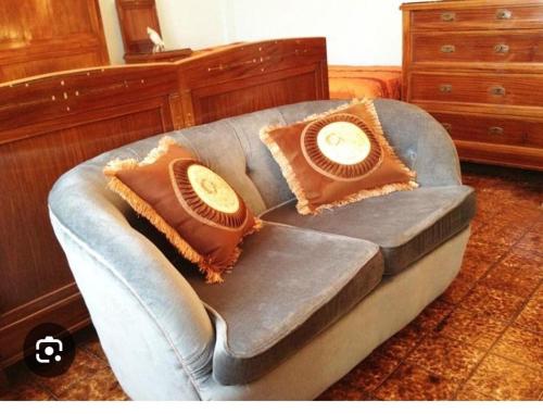 a couch with two pillows on top of it at Villa in campagna in Calvisano