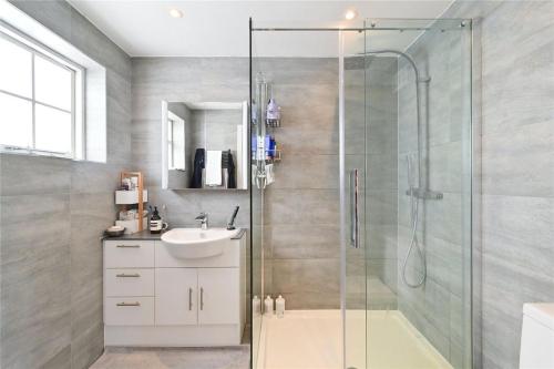 a bathroom with a shower and a sink at Premier 3 Bed Apartment - Covent Garden in London