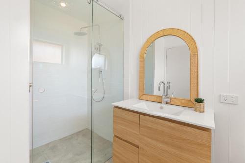 a bathroom with a sink and a shower at Sweeping Panoramic Views - Brand New Beach House in Curl Curl