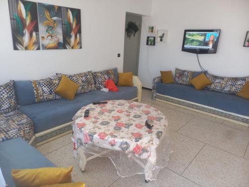 a living room with a couch and a table at RABATCENTRALRESIDENCE in Rabat