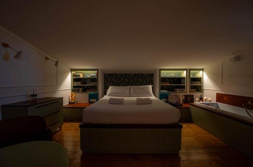a bedroom with a bed with two towels on it at Giardini Penelope Resort e Spa in Ciampino